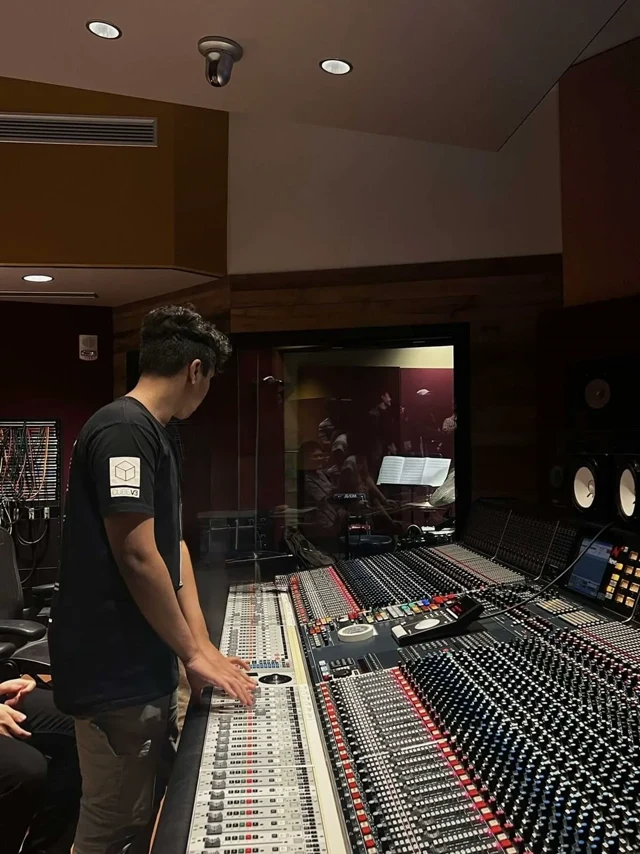 Engineer working at a large mixing console.